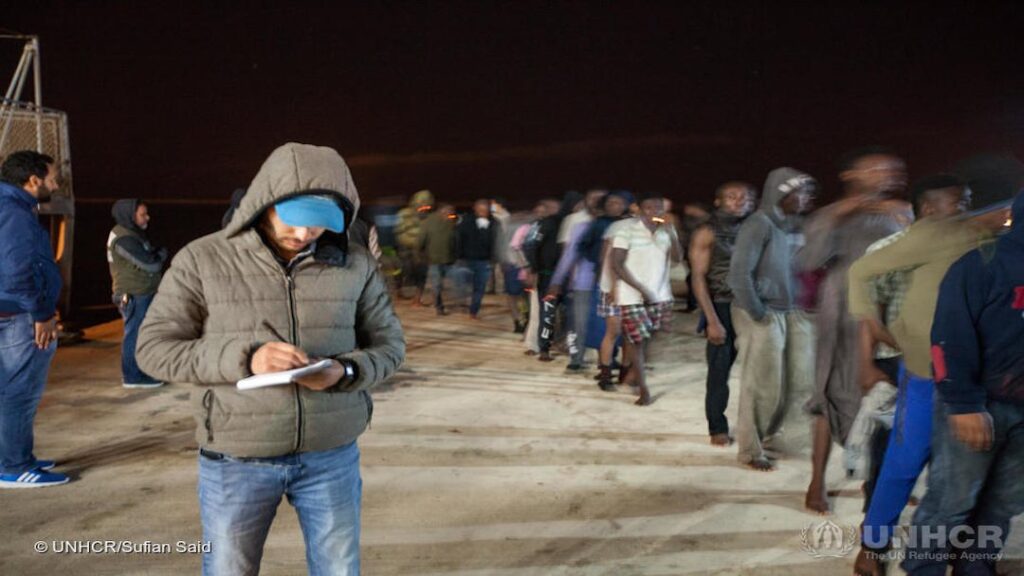 Libya. UNHCR staff assisting refugees and migrants disembarking at Tripoli naval base